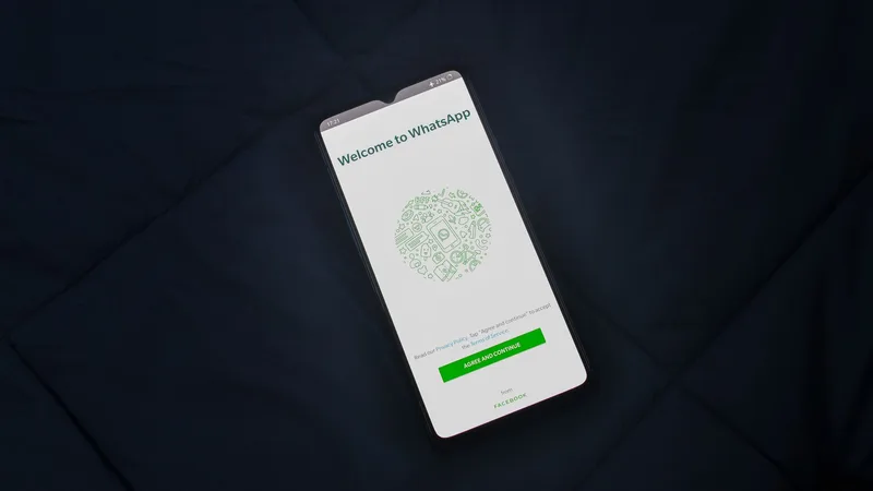 Smartphone showing WhatsApp interface with multiple conversations active