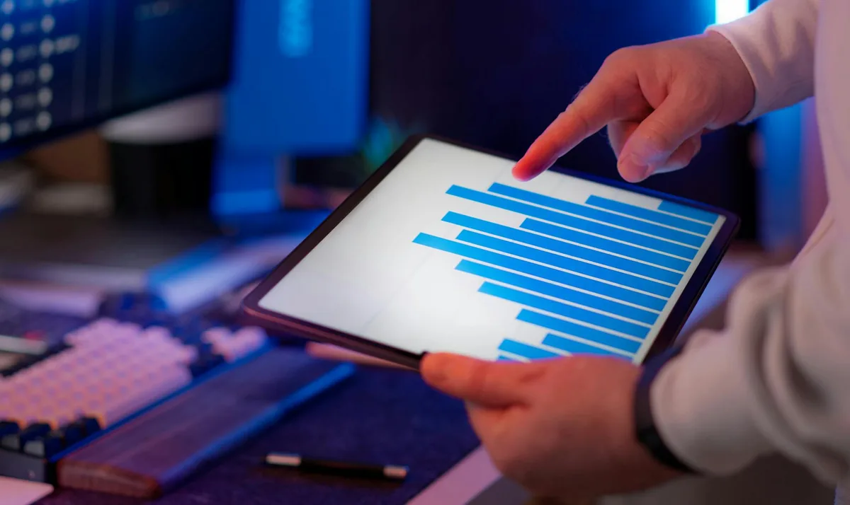 A hand holding a smartphone with a messaging app open, representing business communication tools