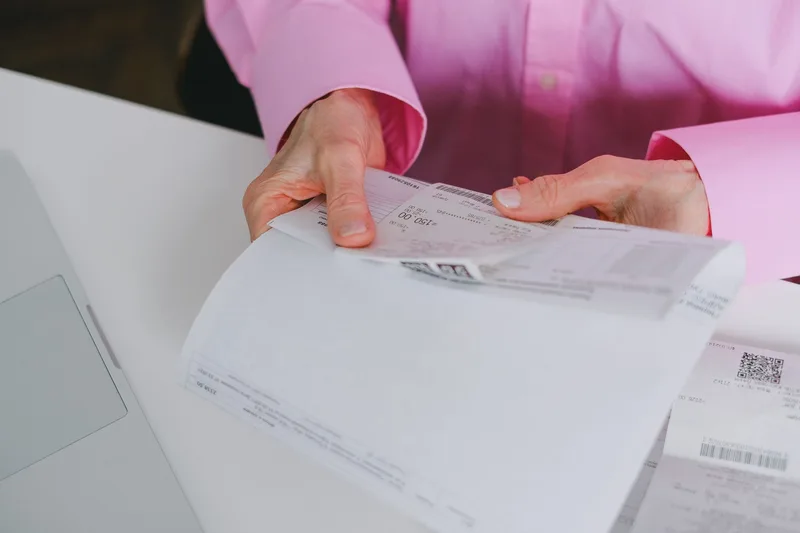 Business person organizing paper receipts on a desk