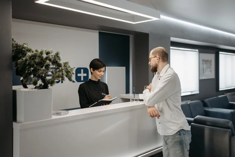 Clinic reception staff managing patient enquiries